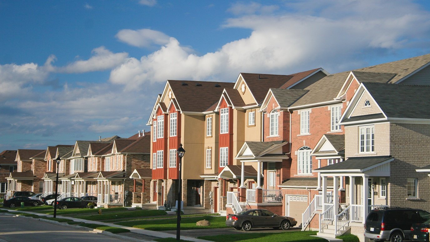 A view of suburban houses lined up in a row.